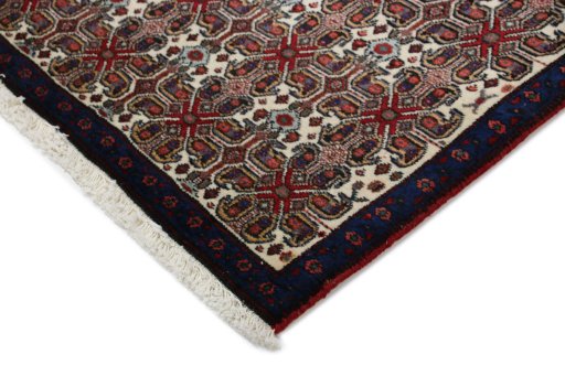 Backside of handmade 1960s Senneh rug showing knot structure and weave density