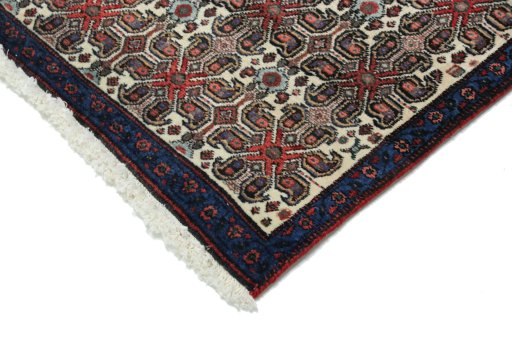 Backside of handmade 1950s Senneh rug showing knot structure and weave density