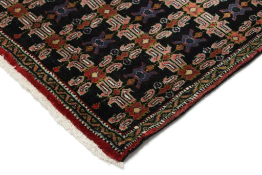 Backside of handmade 1950s Senneh rug showing knot structure and weave density