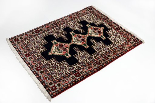Corner detail of 1990s Senneh rug showing border pattern and Wool pile