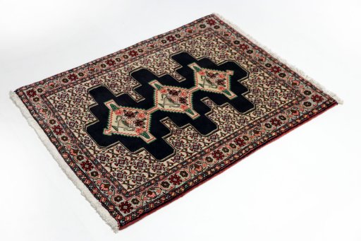 Corner detail of 1990s Senneh rug showing border pattern and Wool pile
