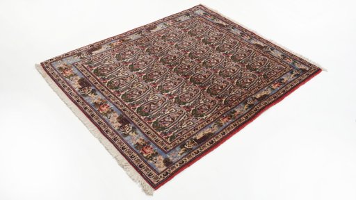 Corner detail of 1950s Senneh rug showing border pattern and Wool pile
