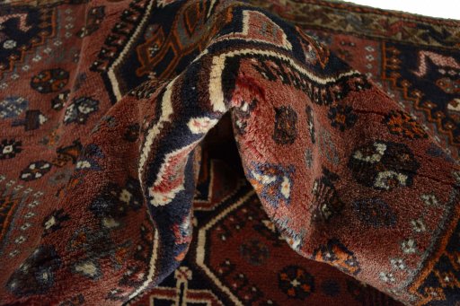 Corner detail of 2000s Shiraz rug showing border pattern and Wool pile