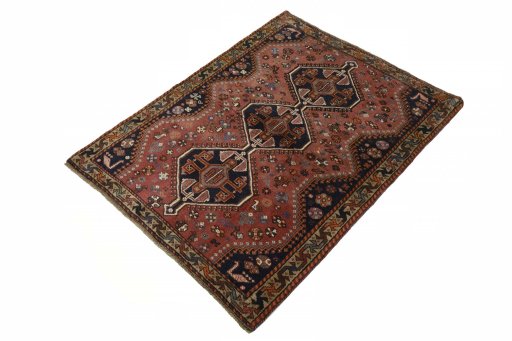 Corner detail of 2000s Shiraz rug showing border pattern and Wool pile
