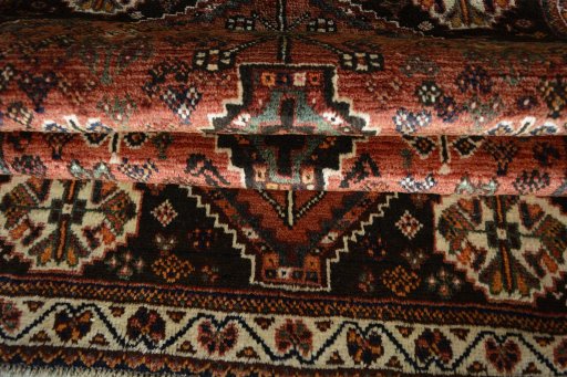 Corner detail of 2000s Shiraz rug showing border pattern and Wool pile