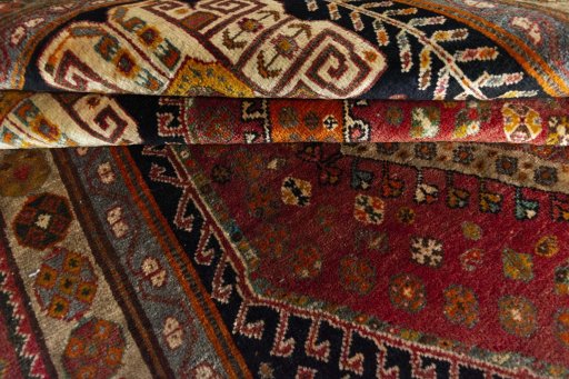 Corner detail of 2000s Shiraz rug showing border pattern and Wool pile