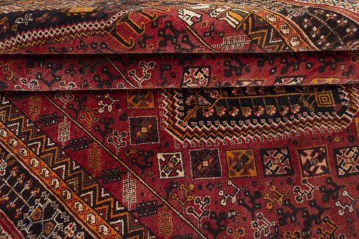Corner detail of 2000s Shiraz rug showing border pattern and Wool pile