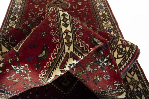 Corner detail of 2000s Shiraz rug showing border pattern and Wool pile