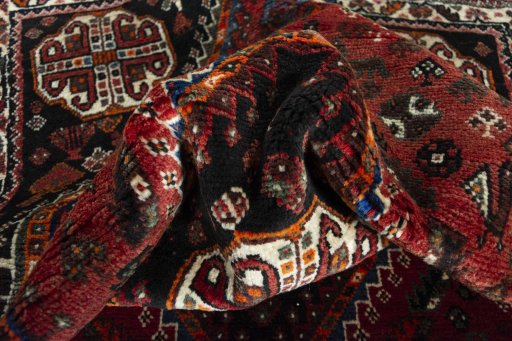 Corner detail of 2000s Shiraz rug showing border pattern and Wool pile