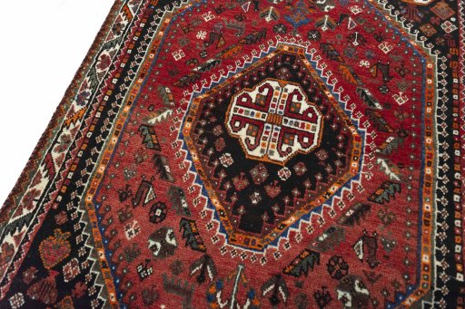 Backside of handmade 2000s Shiraz rug showing knot structure and weave density