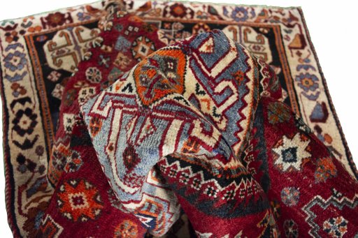 Corner detail of 2000s Shiraz rug showing border pattern and Wool pile
