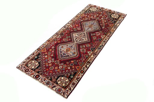 Corner detail of 2000s Shiraz rug showing border pattern and Wool pile