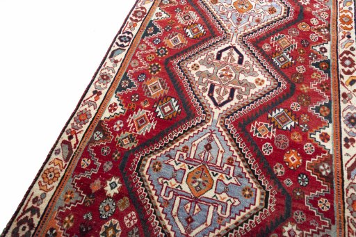 Backside of handmade 2000s Shiraz rug showing knot structure and weave density