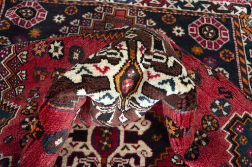 Corner detail of 2000s Shiraz rug showing border pattern and Wool pile