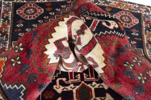 Corner detail of 2000s Shiraz rug showing border pattern and Wool pile