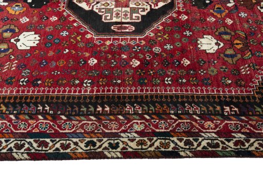 Corner detail of 2000s Shiraz rug showing border pattern and Wool pile
