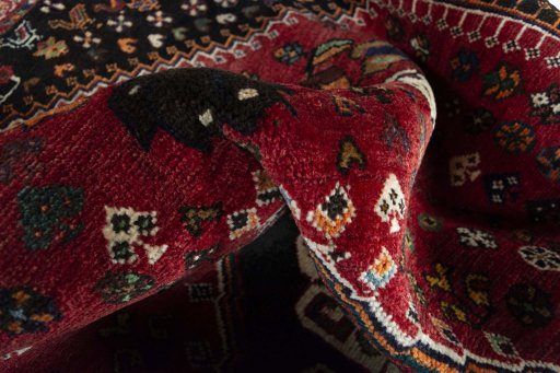 Surface texture of 2000s Shiraz rug with natural Wool and intricate pattern