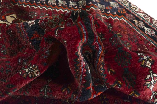 Corner detail of 2000s Shiraz rug showing border pattern and Wool pile