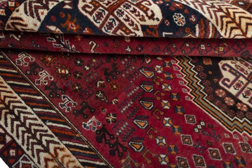 Corner detail of 2000s Shiraz rug showing border pattern and Wool pile