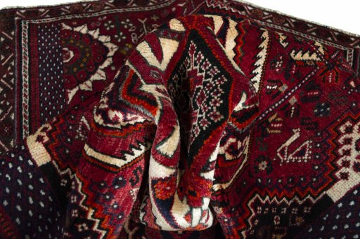 Corner detail of 2000s Shiraz rug showing border pattern and Wool pile