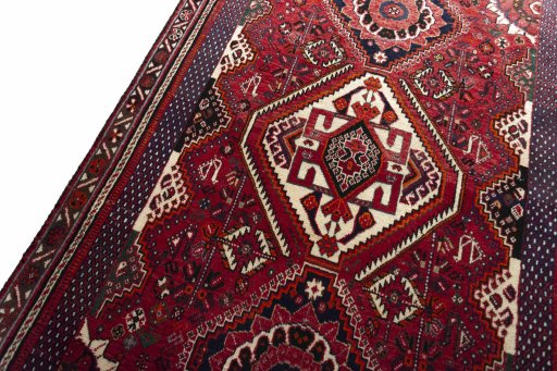 Backside of handmade 2000s Shiraz rug showing knot structure and weave density