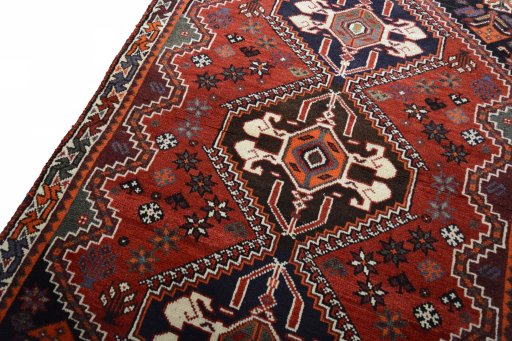 Backside of handmade 2000s Shiraz rug showing knot structure and weave density