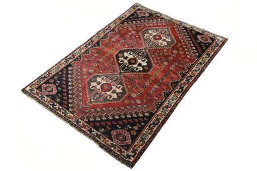 Corner detail of 2000s Shiraz rug showing border pattern and Wool pile