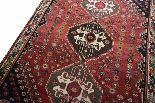 Backside of handmade 2000s Shiraz rug showing knot structure and weave density
