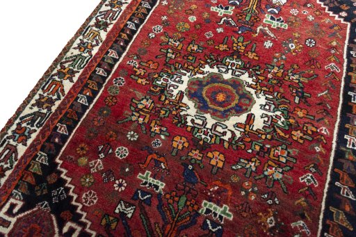 Backside of handmade 2000s Shiraz rug showing knot structure and weave density