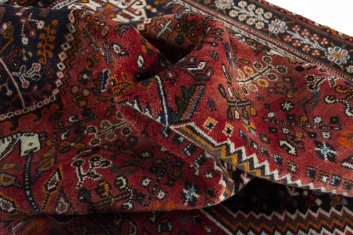 Surface texture of 2000s Shiraz rug with natural Wool and intricate pattern
