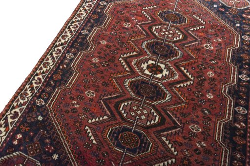 Backside of handmade 2000s Shiraz rug showing knot structure and weave density
