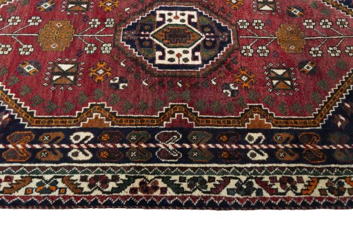 Corner detail of 2000s Shiraz rug showing border pattern and Wool pile