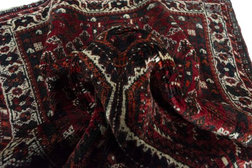 Corner detail of 2000s Shiraz rug showing border pattern and Wool pile