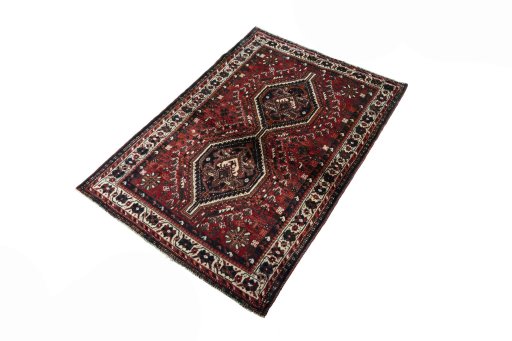 Corner detail of 2000s Shiraz rug showing border pattern and Wool pile