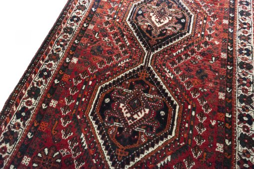 Backside of handmade 2000s Shiraz rug showing knot structure and weave density