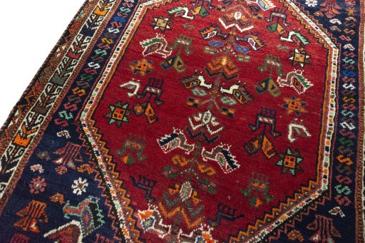 Backside of handmade 2000s Shiraz rug showing knot structure and weave density