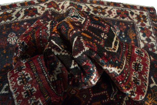 Corner detail of 2000s Shiraz rug showing border pattern and Wool pile