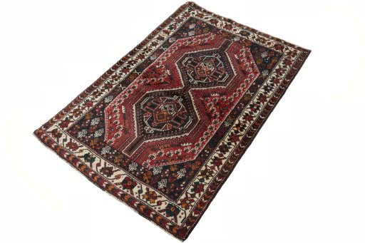 Corner detail of 2000s Shiraz rug showing border pattern and Wool pile