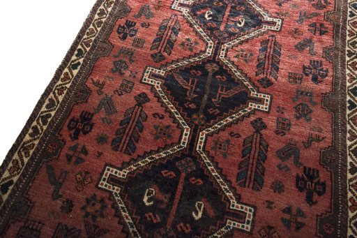 Backside of handmade 2000s Shiraz rug showing knot structure and weave density