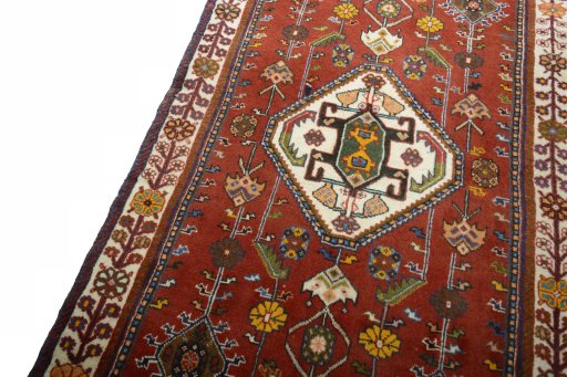 Backside of handmade 2000s Shiraz rug showing knot structure and weave density