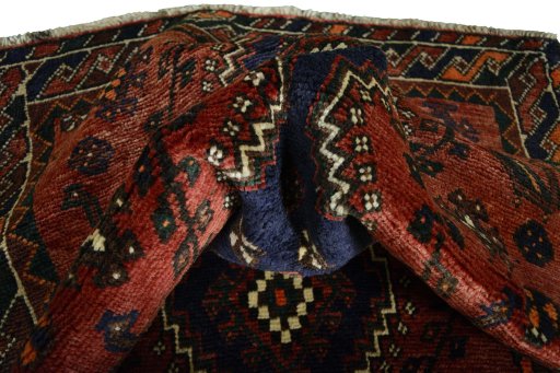 Corner detail of 2000s Shiraz rug showing border pattern and Wool pile