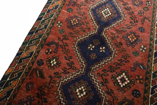 Backside of handmade 2000s Shiraz rug showing knot structure and weave density