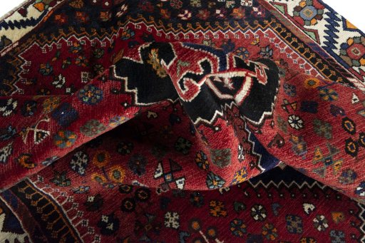 Corner detail of 2000s Shiraz rug showing border pattern and Wool pile