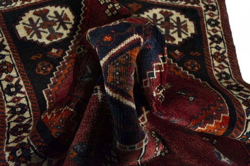 Corner detail of 2000s Shiraz rug showing border pattern and Wool pile