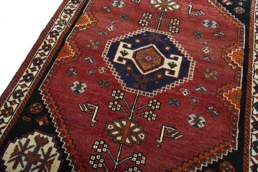 Backside of handmade 2000s Shiraz rug showing knot structure and weave density