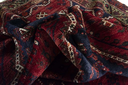 Corner detail of 2000s Shiraz rug showing border pattern and Wool pile