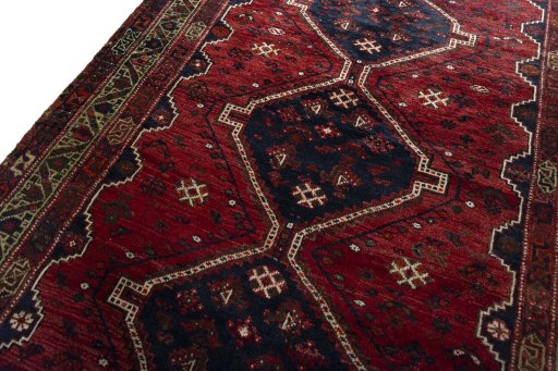 Backside of handmade 2000s Shiraz rug showing knot structure and weave density