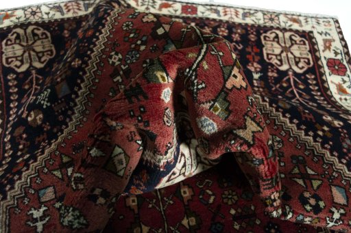 Corner detail of 2000s Shiraz rug showing border pattern and Wool pile