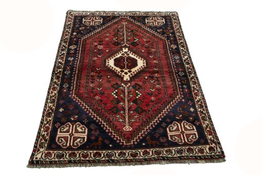Surface texture of 2000s Shiraz rug with natural Wool and intricate pattern
