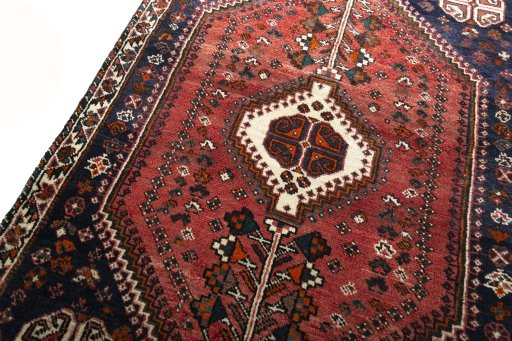 Backside of handmade 2000s Shiraz rug showing knot structure and weave density